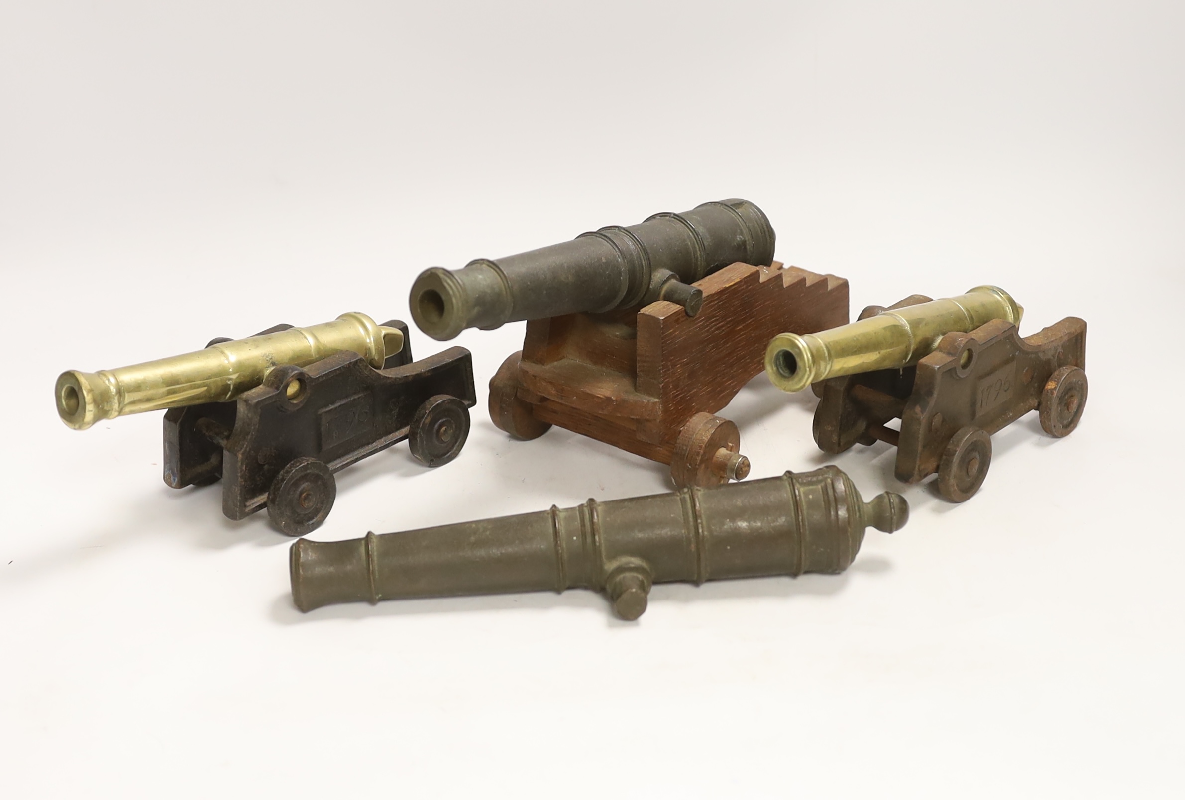 Two pairs of cast metal cannons, three on carriages